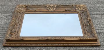 A large modern gilt-framed bevelled mirror. 129 x 98.5 cm.