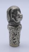 A white metal dog's head form walking stick handle. 7 cm high.