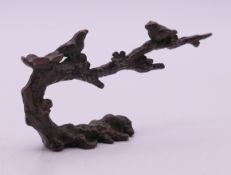 A Japanese bronze of two birds perched on a blossom tree branch. 8.5 cm long, 4.5 cm high.