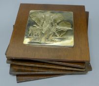 A set of five Franklin Mint sterling silver on mahogany wall plaques featuring the artwork of