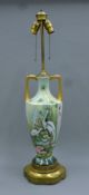 A porcelain lamp decorated with birds. 85 cm high.