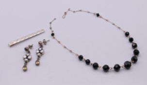 A pair of silver, citrine and pearl earrings, a silver tie clip and a necklace.