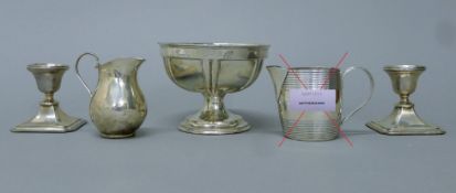 Two silver candlesticks, a small silver pedestal bowl and a small silver jug. The bowl 9 cm high.