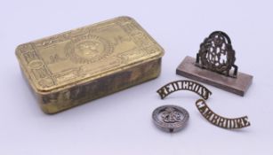A WWI silver services rendered or 'wound' badge, a 1914 brass Christmas tin,