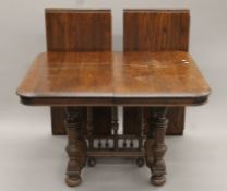 A 19th century French oak two-leaf dining table.