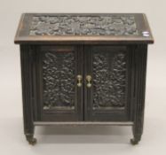 A small Victorian carved oak cupboard. 63 cm wide x 60 cm high.