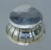 A silver inkwell. 115 cm diameter.