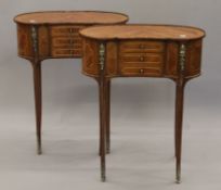 A pair of 19th century-style three-drawer side tables. Each 57 cm wide.
