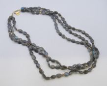 A Brooski three-strand labradorite necklace with silver gilt clasp. 88 cm long.