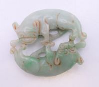 A jade roundel of two dogs-of-fo. 5 x 5.5 cm.