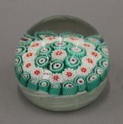 A millefiori glass paperweight with 1846 dated cane. 6.5 cm high.