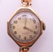 A Rolex 9 ct gold ladies' wristwatch. 2.5 x 3.5 cm. 21 grammes total weight.