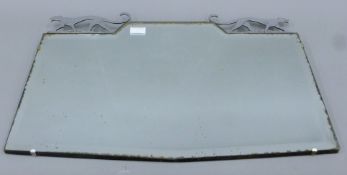 An Art Deco mirror surmounted with a pair of jaguars. 65 cm wide.