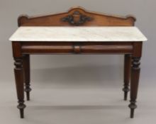 A Victorian marble-topped mahogany washstand. 122 cm wide.