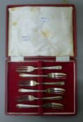A boxed set of six silver cake forks. Each 13 cm long. 115.1 grammes.