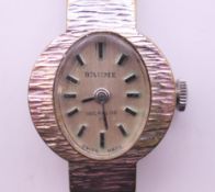 A Baume ladies' wristwatch. 1.75 cm wide.