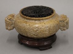 A 19th/20th century Chinese hardstone censer with reticulated hardwood cover and stand. 17 cm wide.