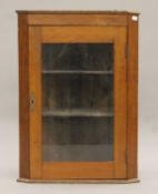 A Victorian glazed mahogany corner cupboard. 53 cm wide x 74.5 cm high.