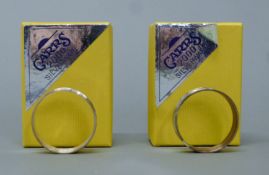 Two boxed silver napkin rings. Each 4.5 cm diameter. 24 grammes.