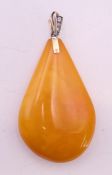 A large butterscotch amber pendant. 7.5 cm high including suspension loop.