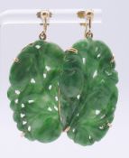 A pair of 9 ct gold and jade earrings. 3.5 x 2 cm.