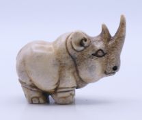 A stag's horn model of a rhinoceros. 3.5 cm high.