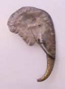 A silver elephant head brooch. 5 cm high.