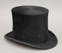 A Henry Heath silk top hat. Inner dimensions 15.5 x 19.5 cm.