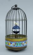 A cloisonne birdcage clock. 20 cm high.