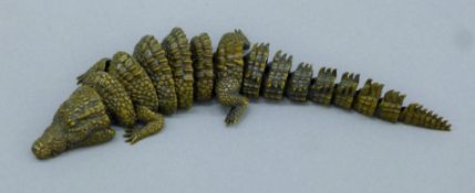 A bronze articulated model of an alligator. 19 cm long.