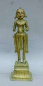 An 18th century Indian bronze deity on stand. 48 cm high.