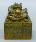 A Chinese bronze seal surmounted with a dragon. 7.5 cm high.