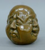 A four-faced bronze Buddha head. 11 cm high.