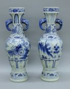 A pair of Chinese blue and white porcelain vases with elephant mask handles. Each 66 cm high.