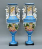 A pair of porcelain vases decorated with Bacchic cherubs. Each 62 cm high.