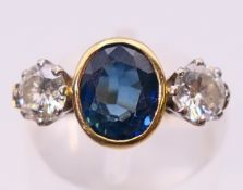 An 18 ct gold, sapphire and diamond three-stone ring,
