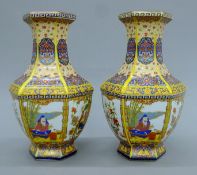 A pair of Chinese porcelain vases decorated with birds and figures. Each 26 cm high.
