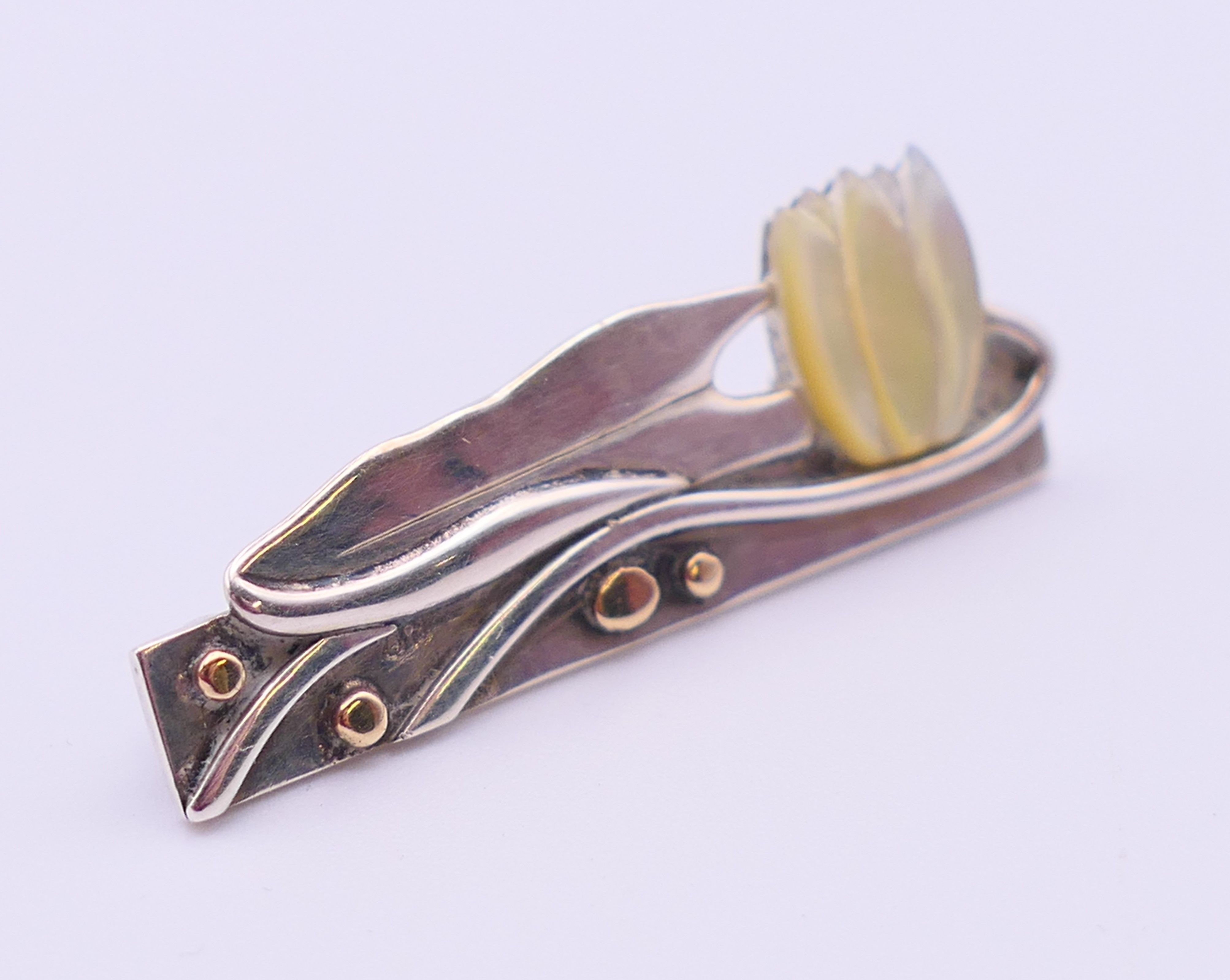 An Ann Powell handmade one-off silver, gold and mother-of-pearl brooch decorated with a lily. 3. - Image 2 of 5