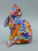 A graffiti-decorated model of a cat. 14 cm high.