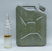 A vintage jerry can and an Esso bottle. The latter 39 cm high.