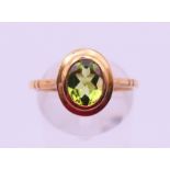 A 9 ct gold peridot ring. Ring size Q/R. 2.8 grammes.