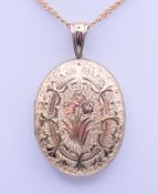A 9 ct gold locket on chain. The locket 5 cm high. 26.1 grammes total weight.