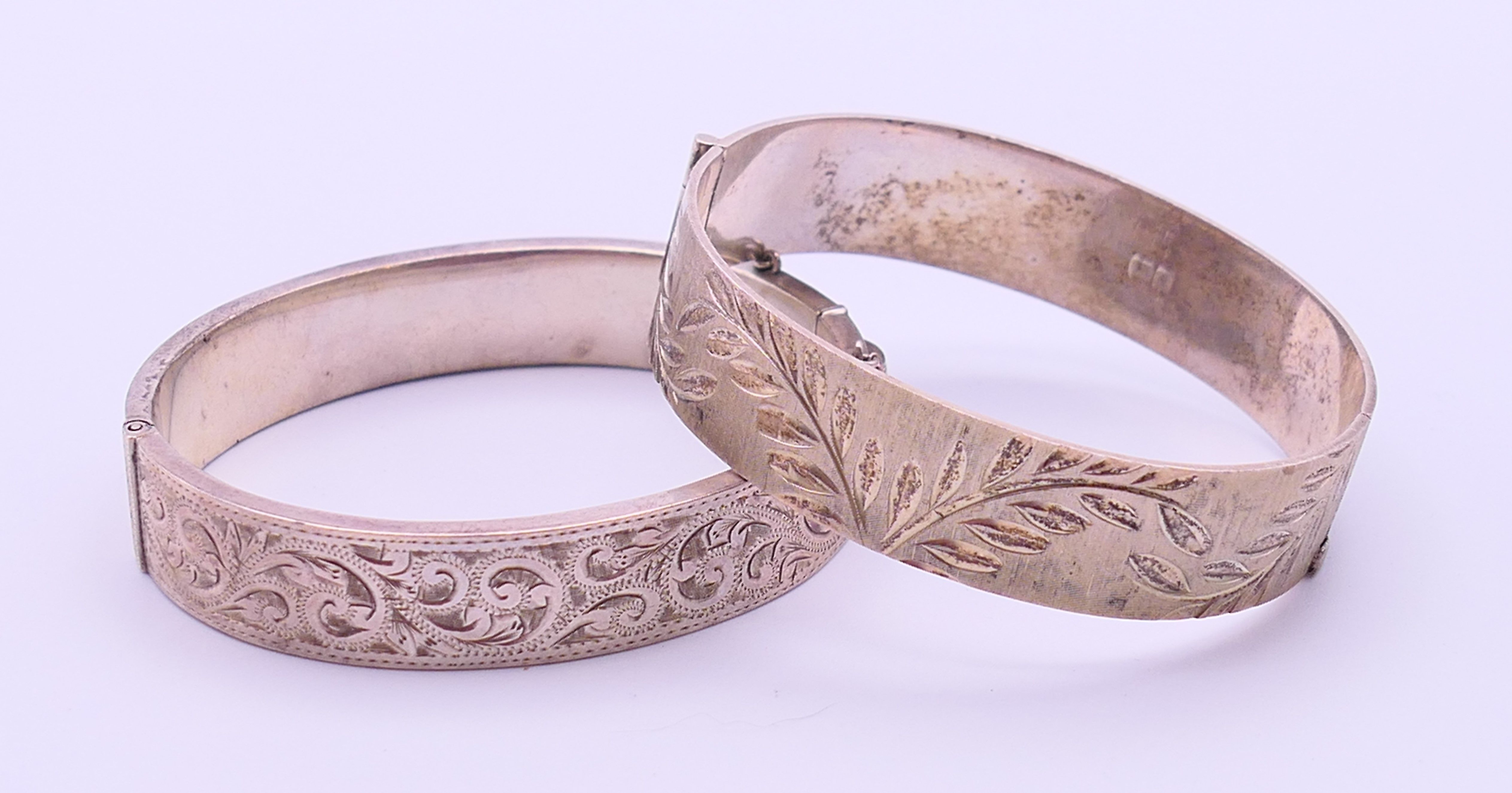 Two silver engraved bangle-form bracelets. Each 5.5 cm inner width. 53.3 grammes.