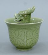 A Chinese celadon porcelain tea bowl centred with a dragon. 9.5 cm high.