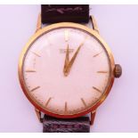 A 9 ct gold Tissot gentlemen's wristwatch. 3.5 cm wide. 30.8 grammes total weight.
