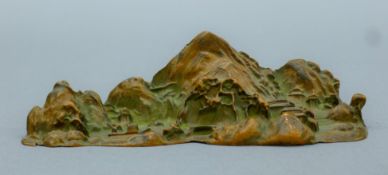 A Chinese bronze brush stand formed as mountains. 14 cm wide.