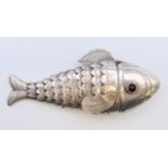 An eastern unmarked silver reticulated fish-form pill box. 9 cm long.