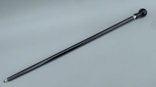 A walking stick, the handle formed as a Porsche gear stick. 94 cm long.