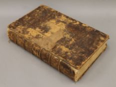 An antique French Bible, lacking title page, map, damaged at edge, folio, calf, very worn,