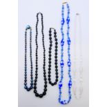 Three vintage black glass necklaces,